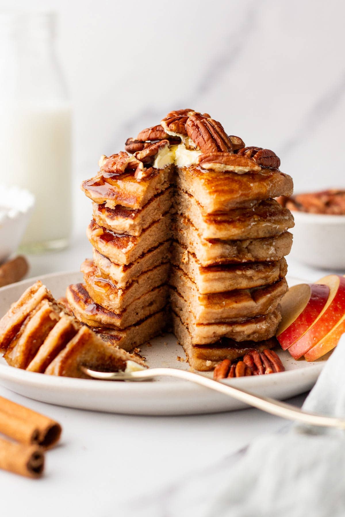 stack of pancakes with a wedge removed to show the golden fluffy interior.