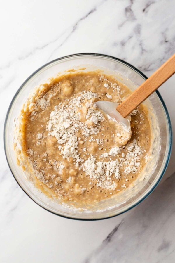 folding dry ingredients into wet ingredients for pancakes.