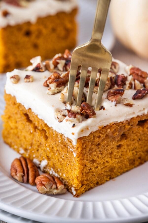 slice of pumpkin cake with a fork digging in.