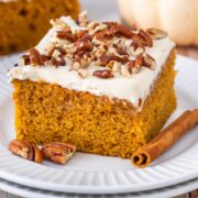 slice of pumpkin sheet cake with maple frosting on a dessert plate.