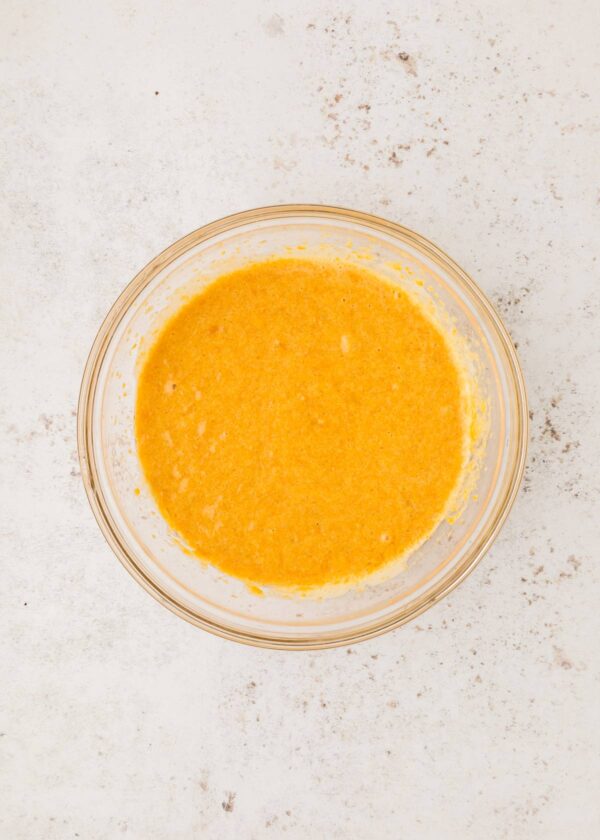 adding sweet potato to whisked wet ingredients.