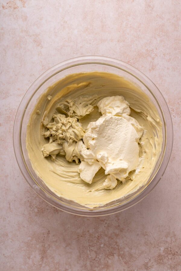 folding whipped cream into pistachio cream.