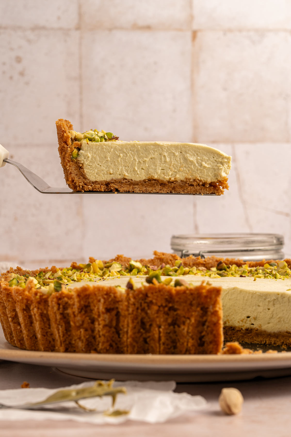 lifting a slice of pistachio cream pie with a spatula.