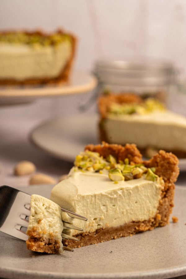 fork cutting into a slice of pistachio pie.