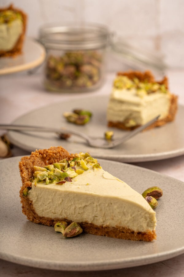 two slices of pistachio pie on dessert plates.