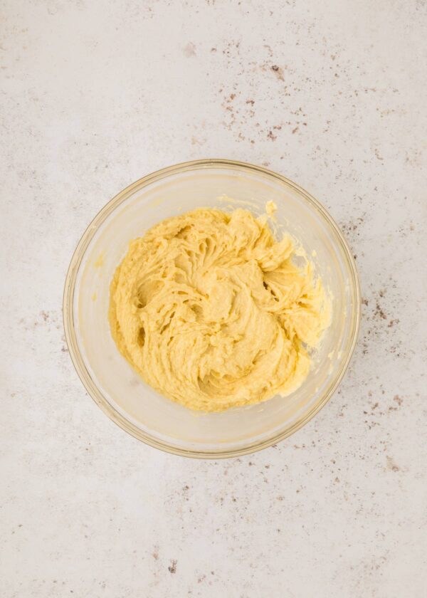 mixing eggs into cookie dough batter.