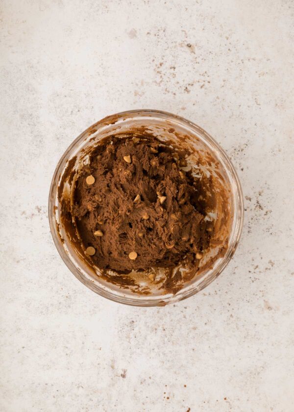 folding peanut butter chips into chocolate cookie dough.