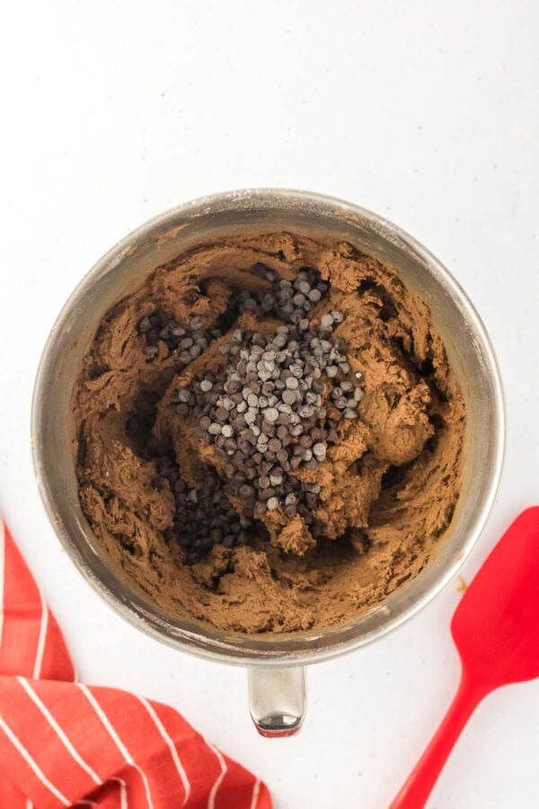 mixing chocolate chips into chocolate cookie dough.