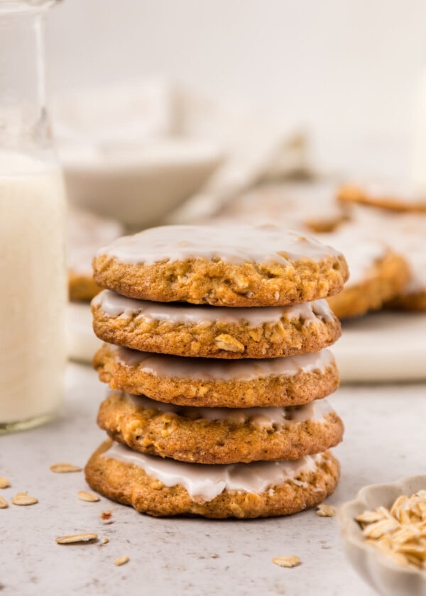 stack of five oatmeal cookies covered with vanilla glaze.