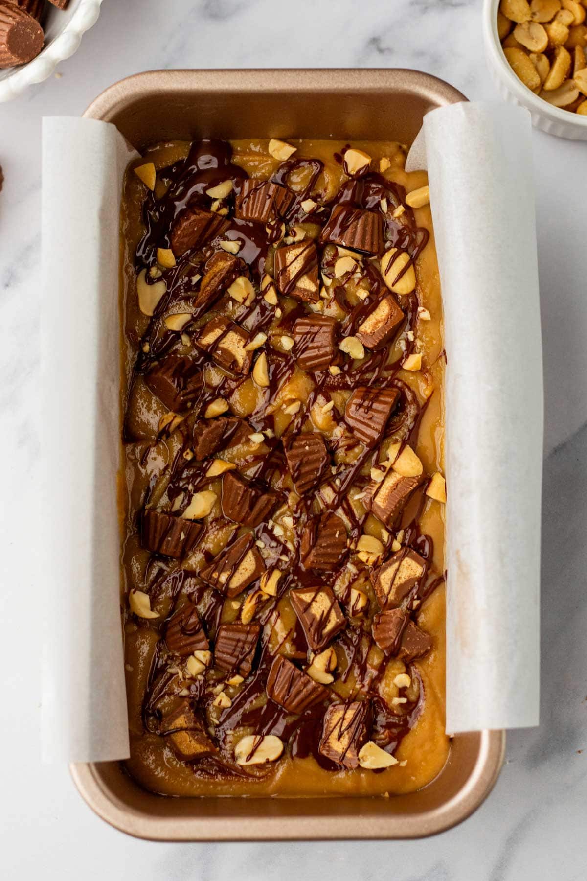 peanut butter fudge topped with peanut butter cups and chopped peanuts.