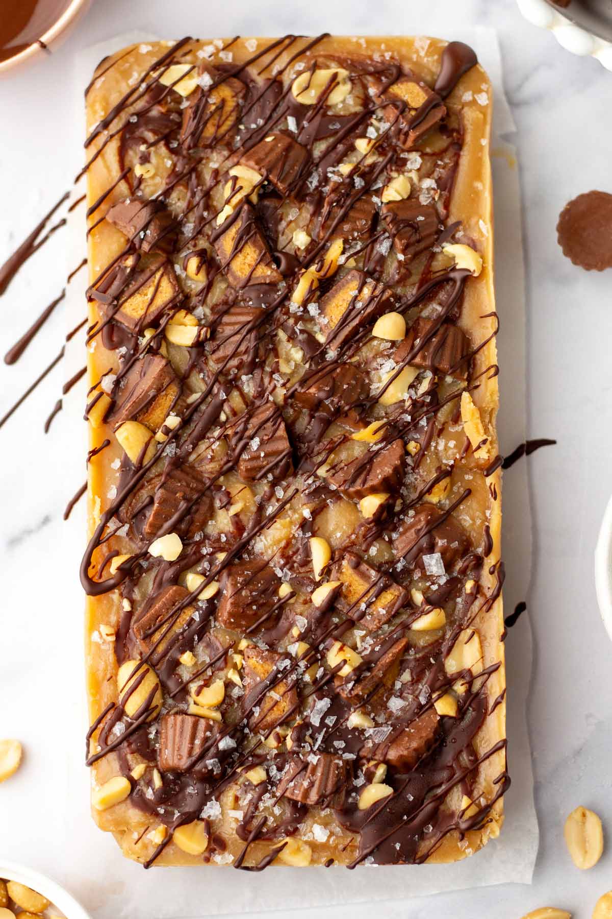 block of uncut peanut butter fudge drizzled with chocolate.
