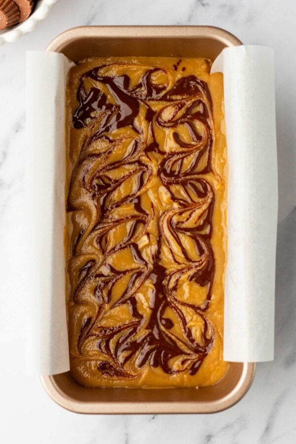 swirls of melted chocolate on top of peanut butter fudge.