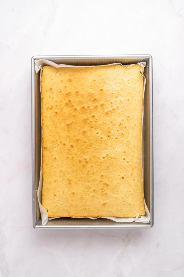 freshly baked vanilla sheet cake still in the baking pan.