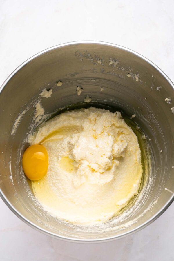 adding eggs to creamed butter and sugar.
