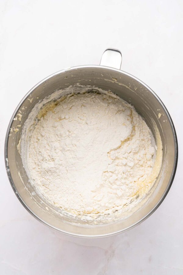 adding dry ingredients to vanilla cake batter.