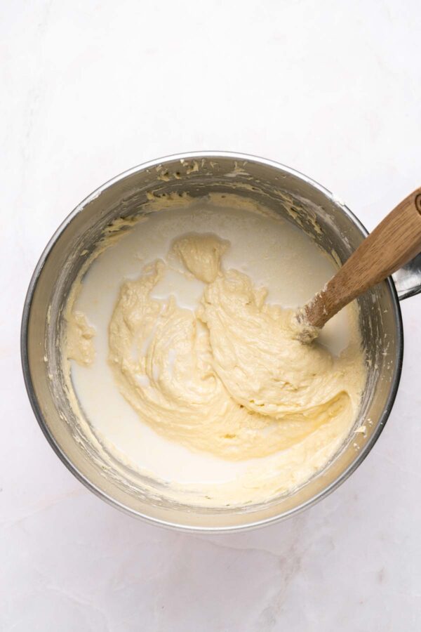 adding buttermilk to vanilla cake batter.