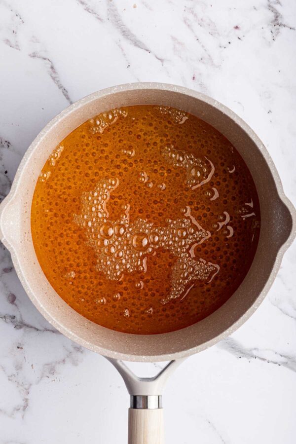 cooking sugar and water to make caramel sauce.