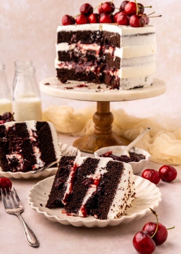 cut slices of black forest cake in front of the rest of the cake.