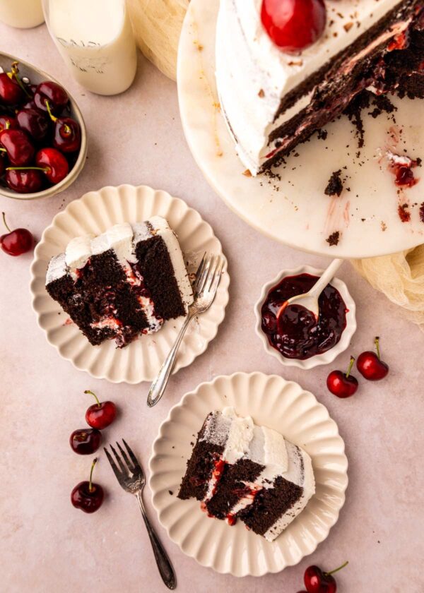 overhead view of slices of chocolate cherry cake on decorative dessert plates.