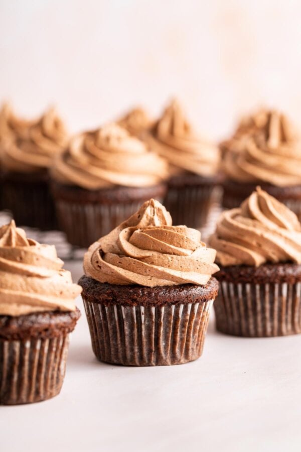 chocolate cupcakes decorated with swirls of chocolate frosting.