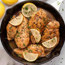 lemon pepper chicken in a cast iron pan.