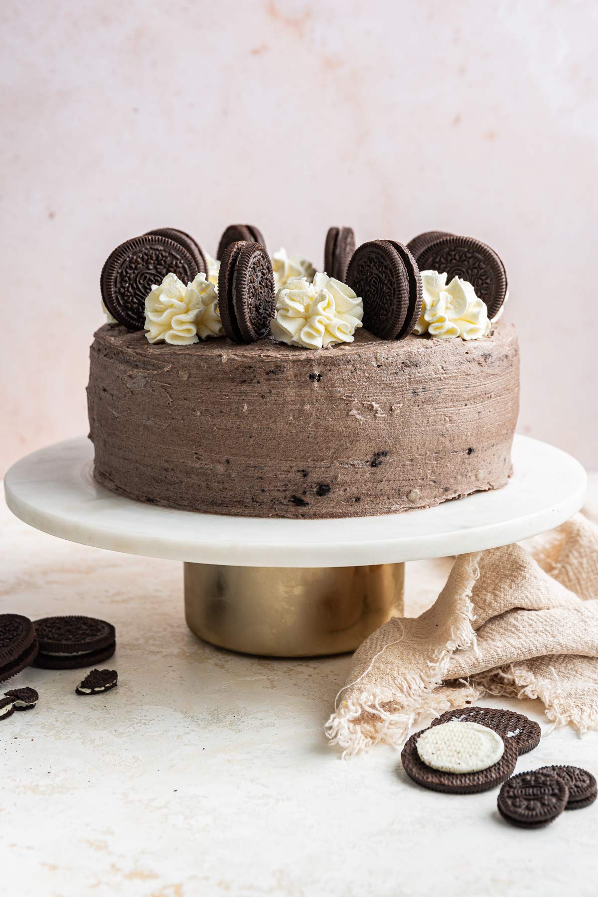 two layer chocolate cake covered with oreo cream cheese frosting.