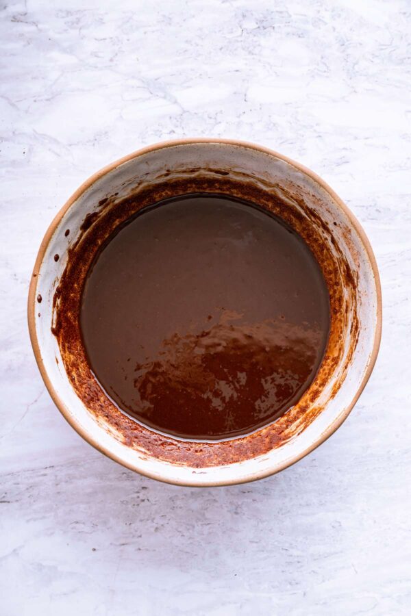 stirring melted butter and cocoa until hydrated and smooth.