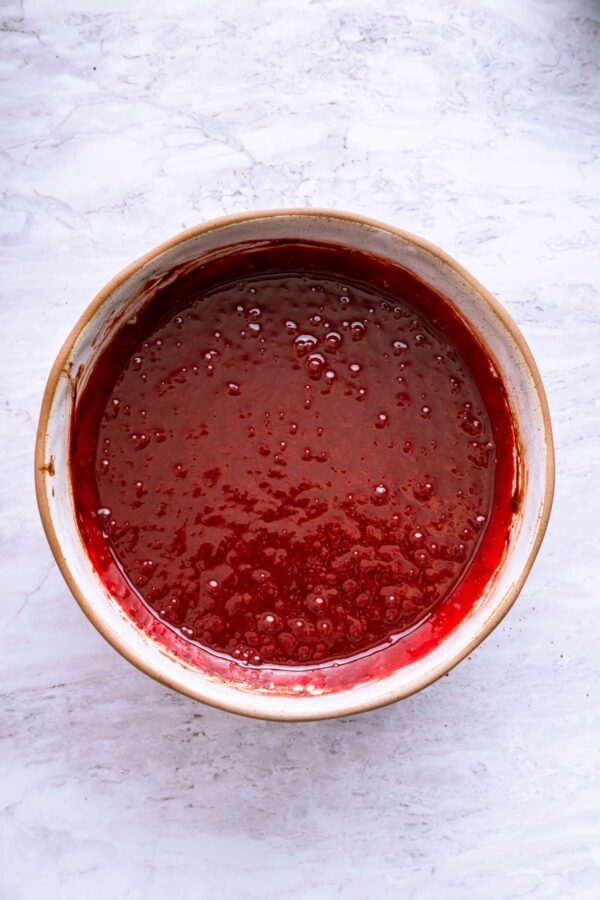 mixing vinegar and red food coloring into brownie batter.