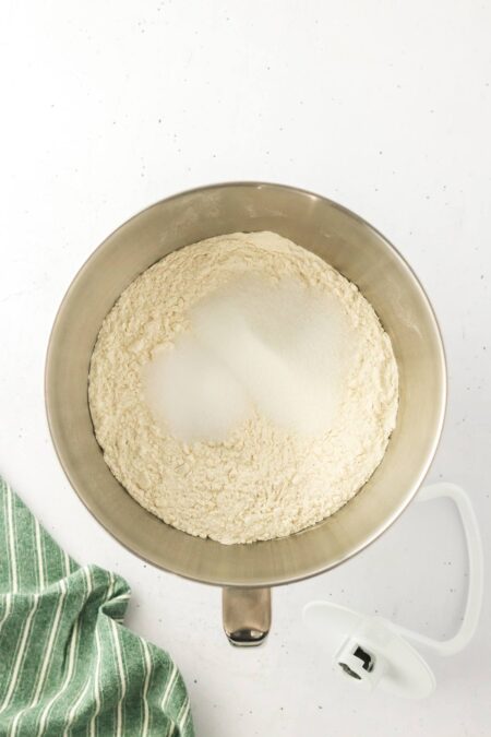 flour, sugar, salt, and yeast in a mixing bowl.