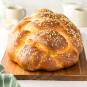 side view of a thick and fluffy loaf of golden brown challah.