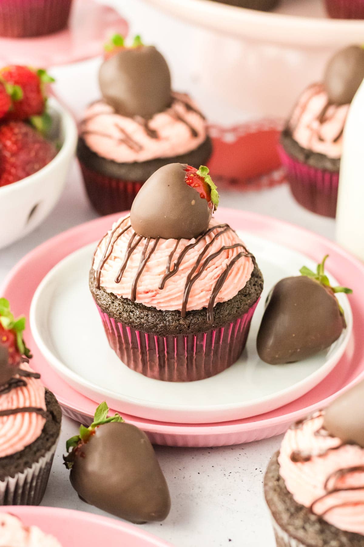 chocolate strawberry cupcake decorated with a chocolate covered strawberry.