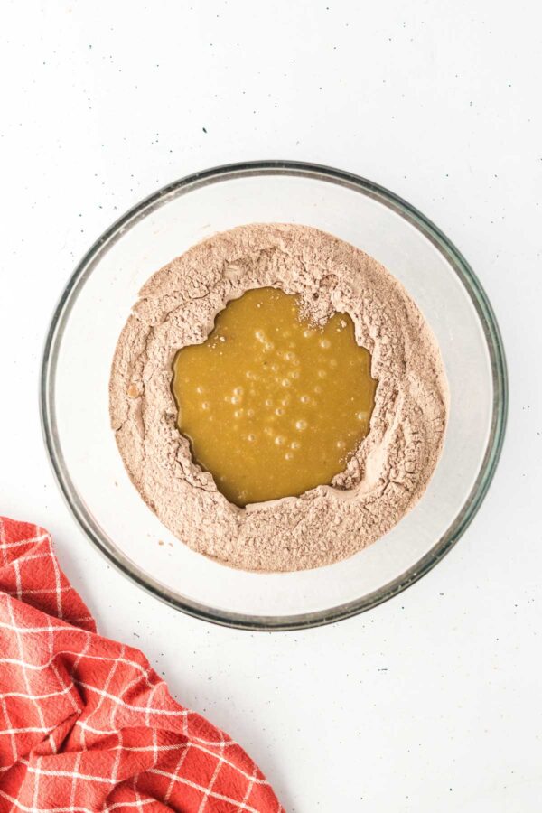 mixing wet cake batter into the dry ingredients.