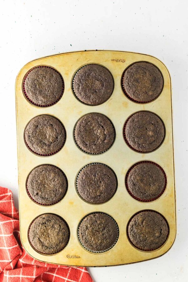 chocolate strawberry cupcakes in a muffin tin.