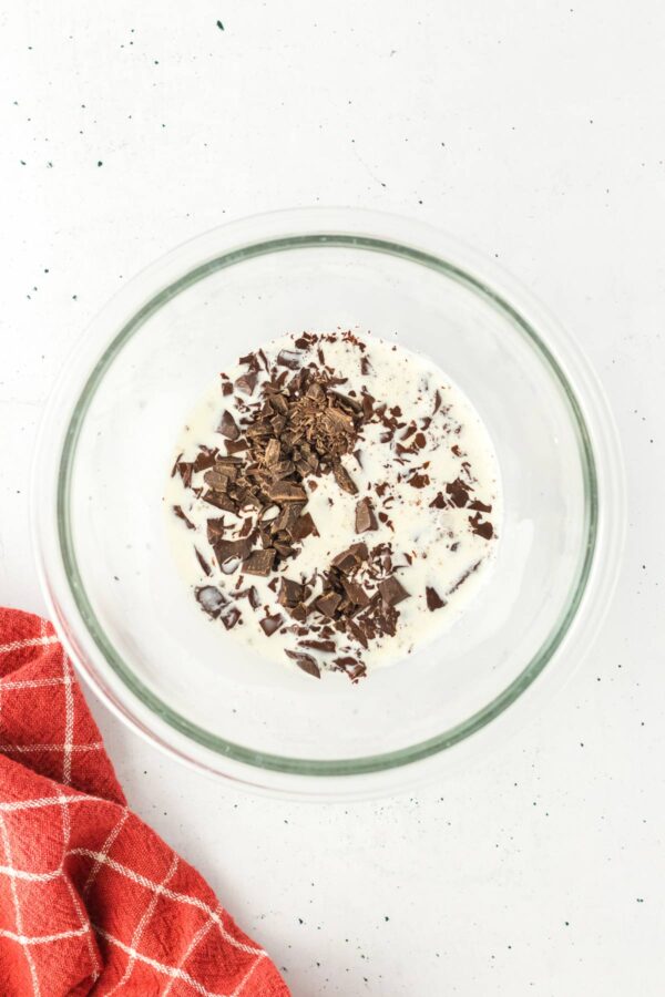chopped chocolate and heated heavy cream in a bowl.