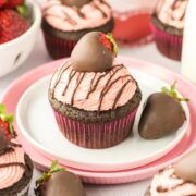 chocolate strawberry cupcake covered with fresh strawberry buttercream and a chocolate covered strawberry.