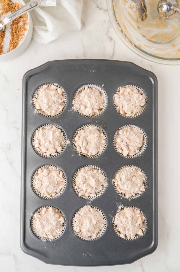 unbaked coffee cake muffins topped with cinnamon streusel.