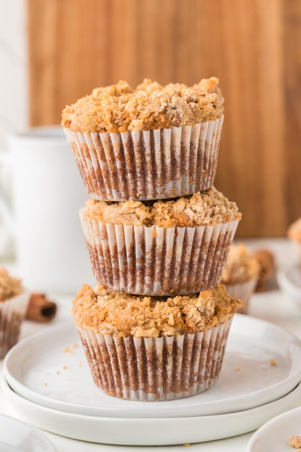 vertical stack of three coffee cake muffins.