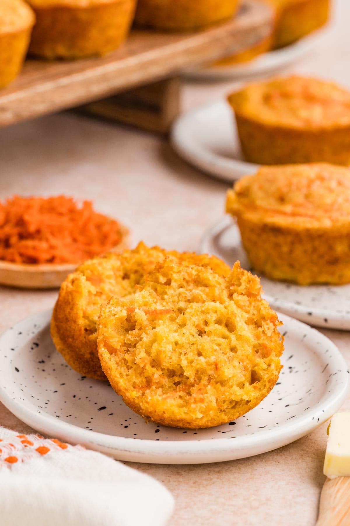 carrot muffin cut in half on a small plate.