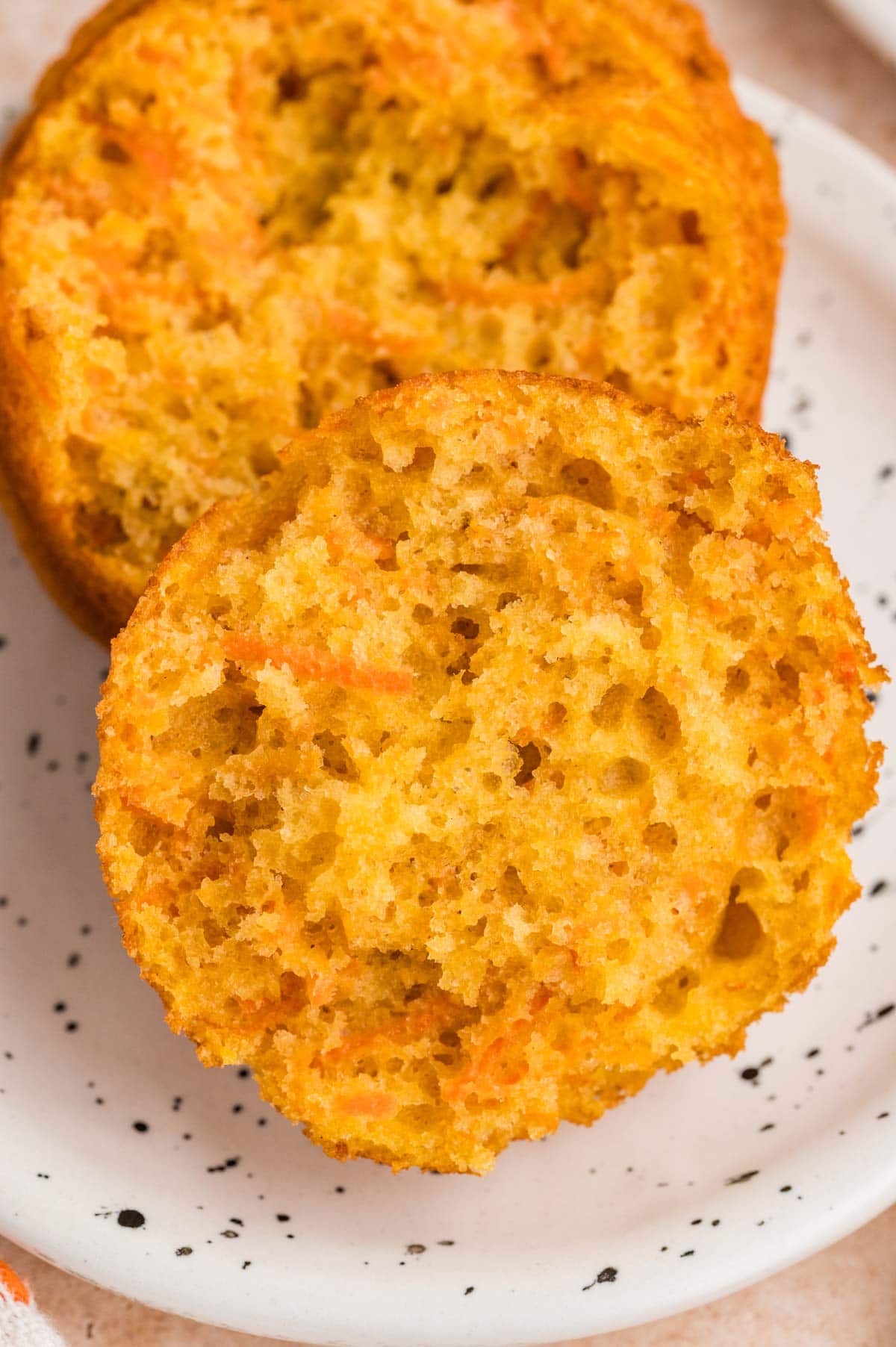 close up view of the inside of a carrot muffin showing the moist interior.