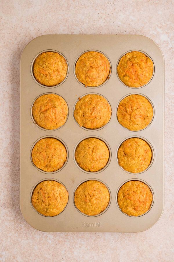 freshly baked carrot muffins still in the muffin tin.