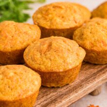 lightly spiced carrot muffins on a wooden board.