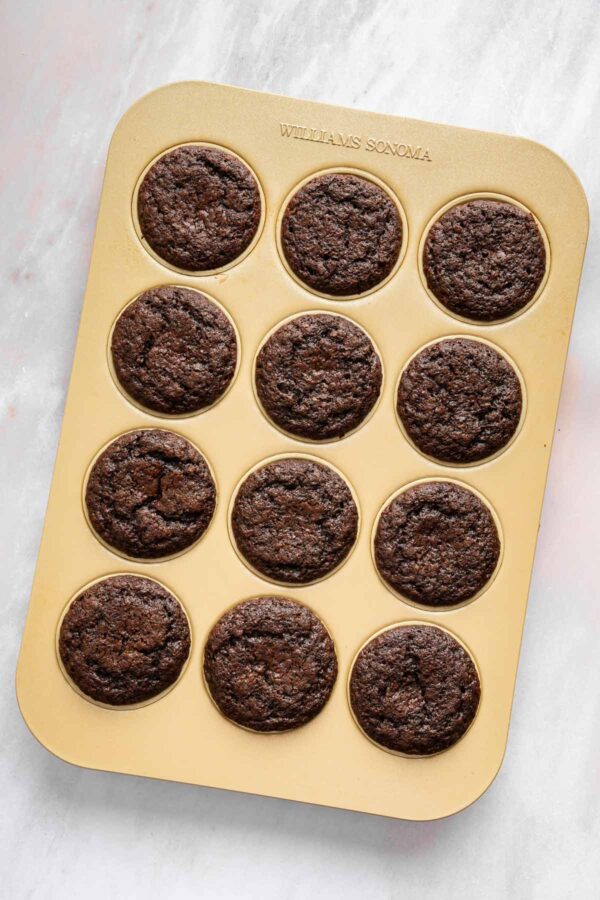 freshly baked chocolate cupcakes still in the muffin tin.