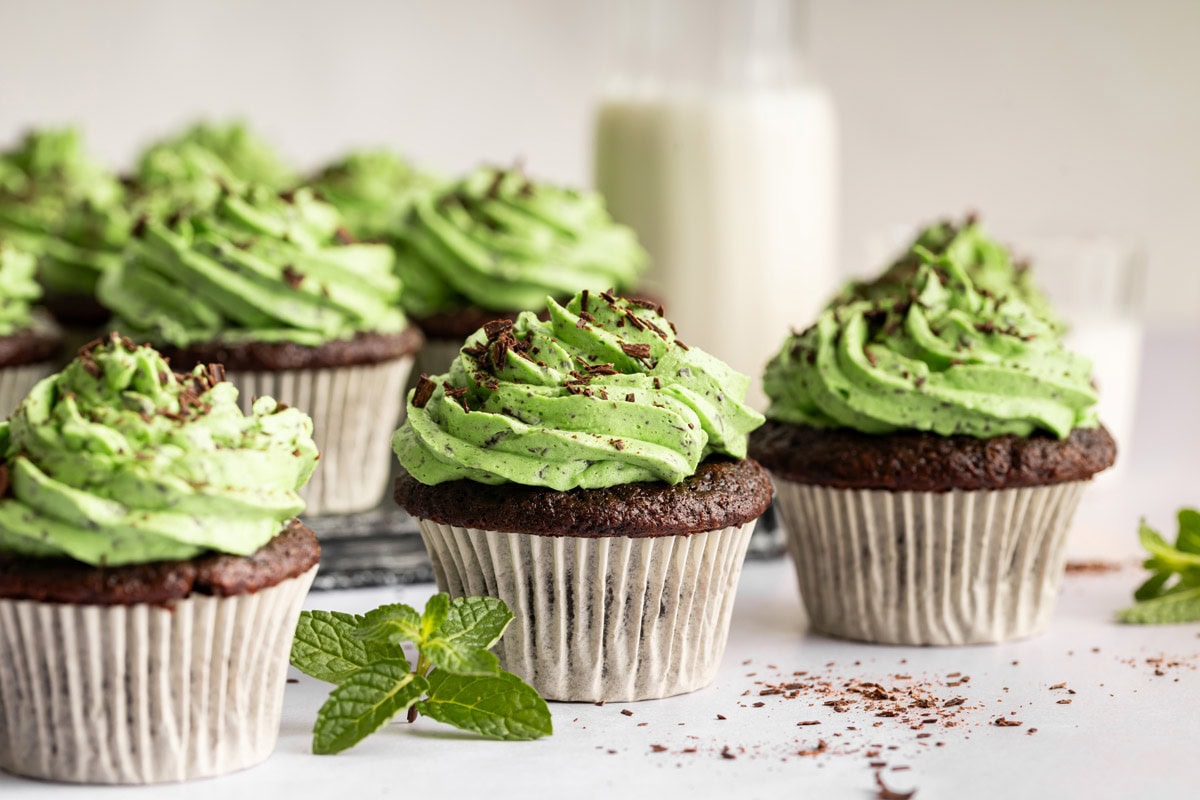 chocolate cupcakes decorated with tall swirls of mint buttercream frosting.