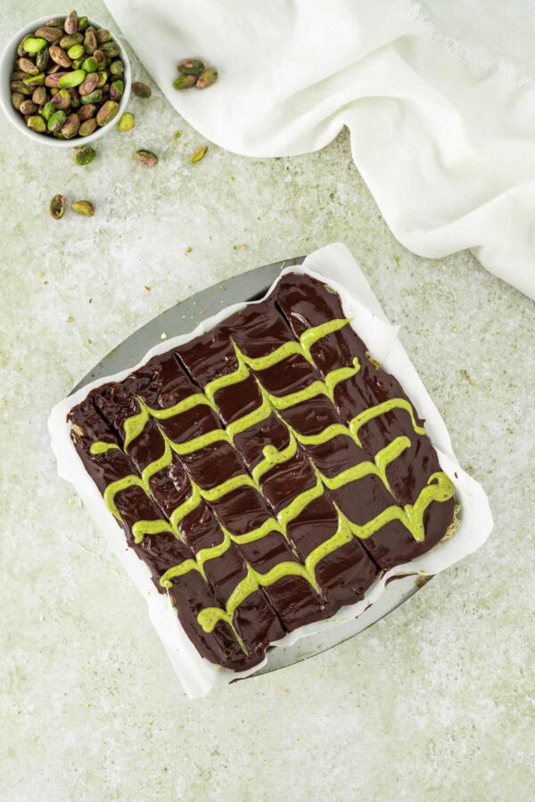 dubai chocolate brownies decorated with chocolate ganache and pistachio cream.