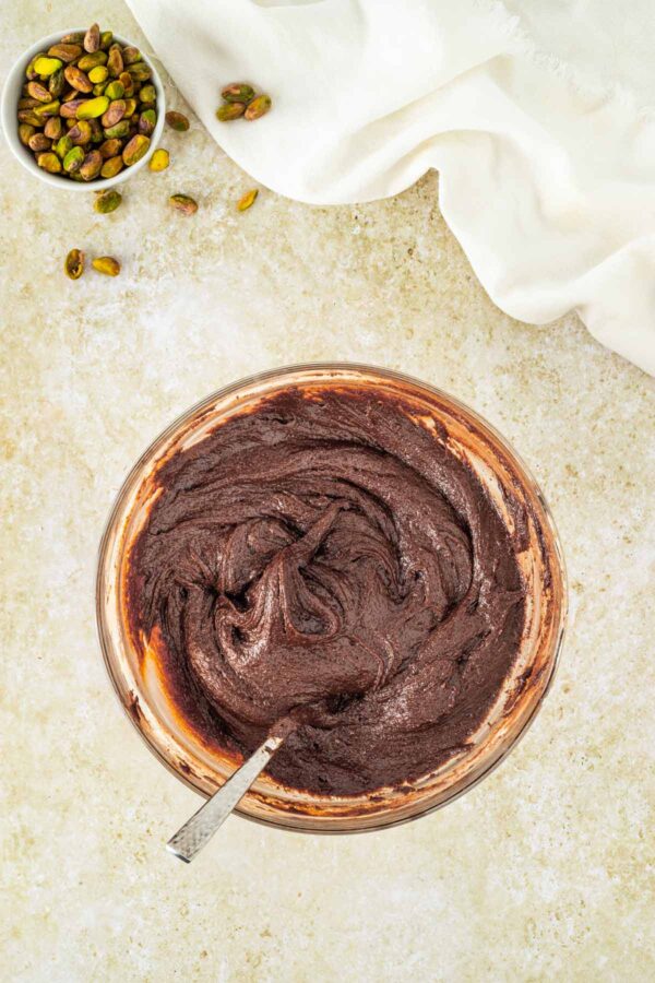 thick and glossy brownie batter in a mixing bowl.