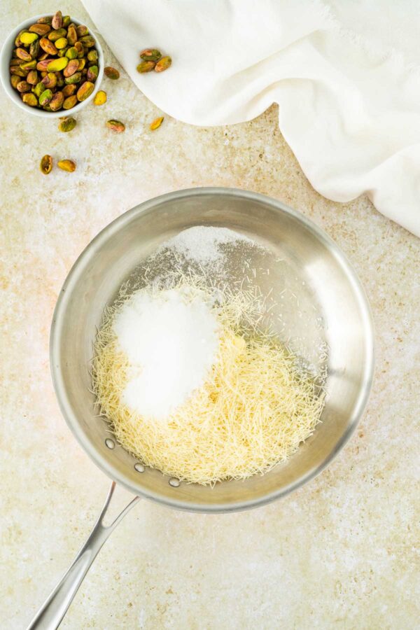 kataifi, butter, and sugar in a frying pan.