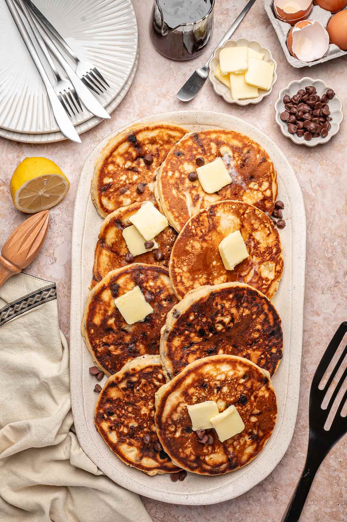large chocolate chip pancakes displayed on a serving platter.