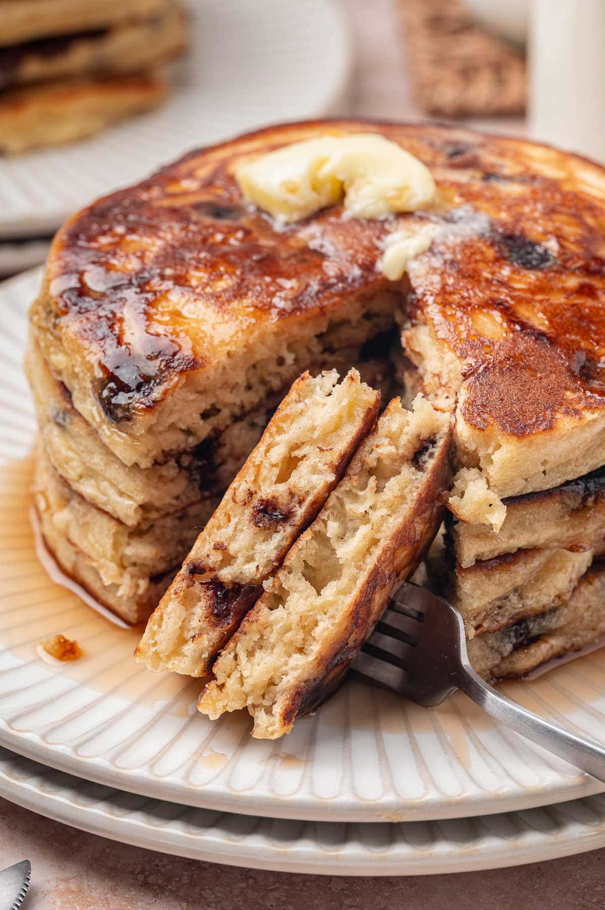 bite of thick, fluffy pancakes on a fork.