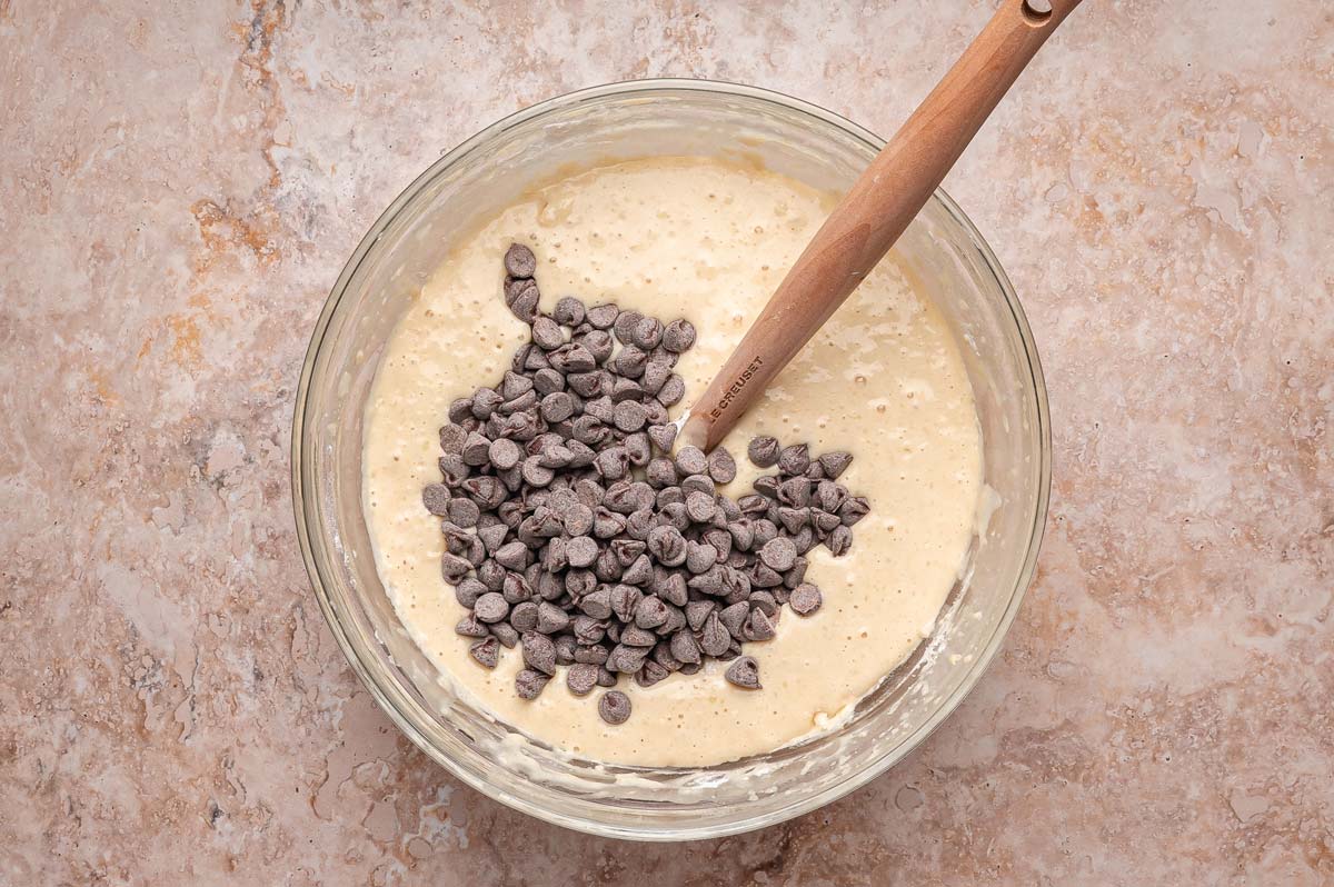 adding chocolate chips to buttermilk pancake batter.