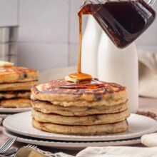 tall stack of fluffy chocolate chip pancakes.